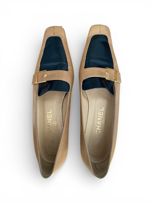 Pair of Chanel loafers on a white background