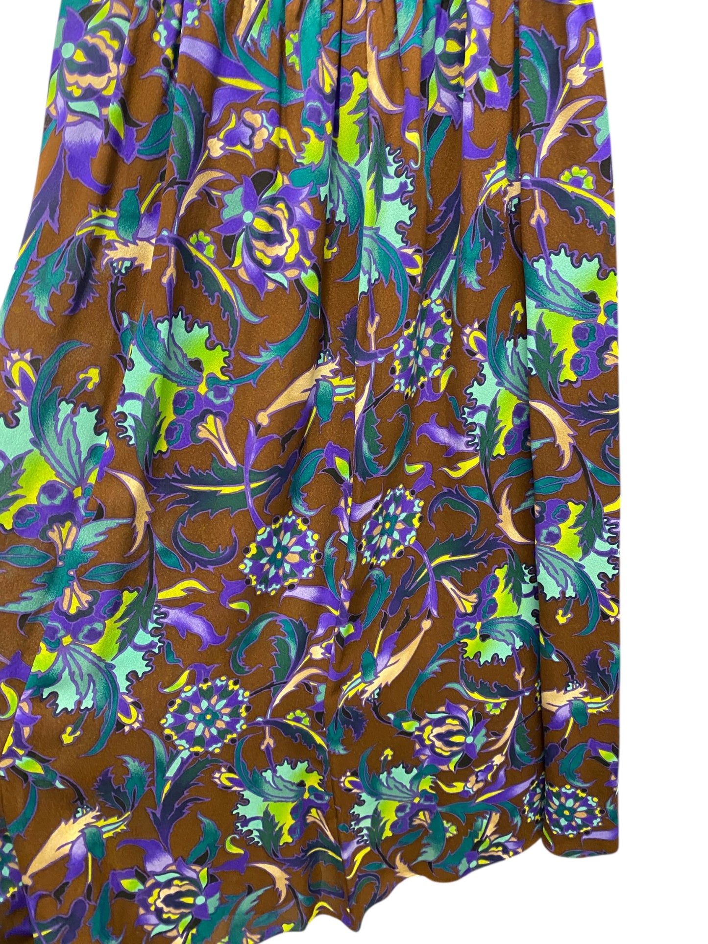 Colorful floral patterned fabric on a brown background