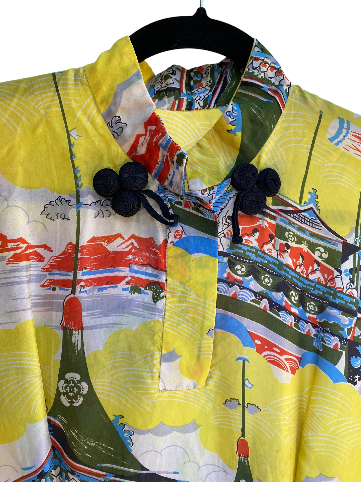 LaliSimone vintage 1940s yellow rayon Pake Muu dress featuring a colorful pagoda novelty print and black frog closures.