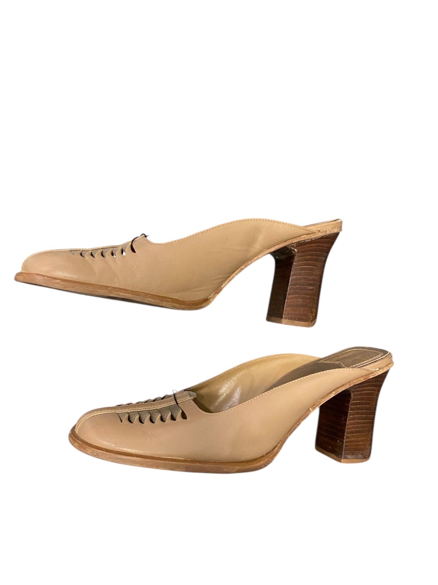 Pair of beige high-heeled shoes on a white background