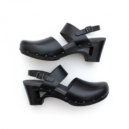 Pair of black clogs with straps on a white background