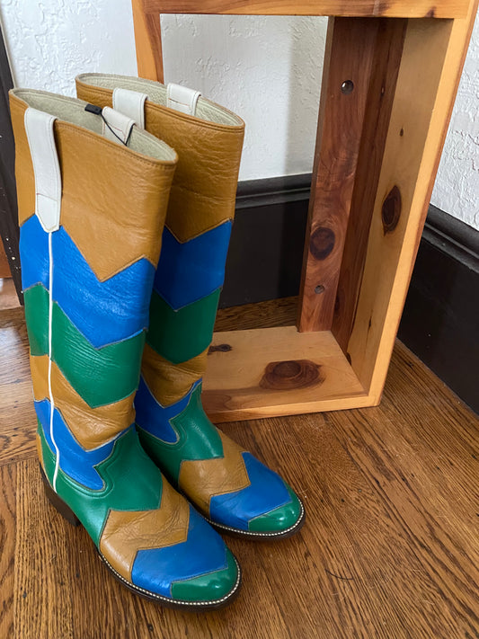 color block chevron riding boots with a wooden stand in the background