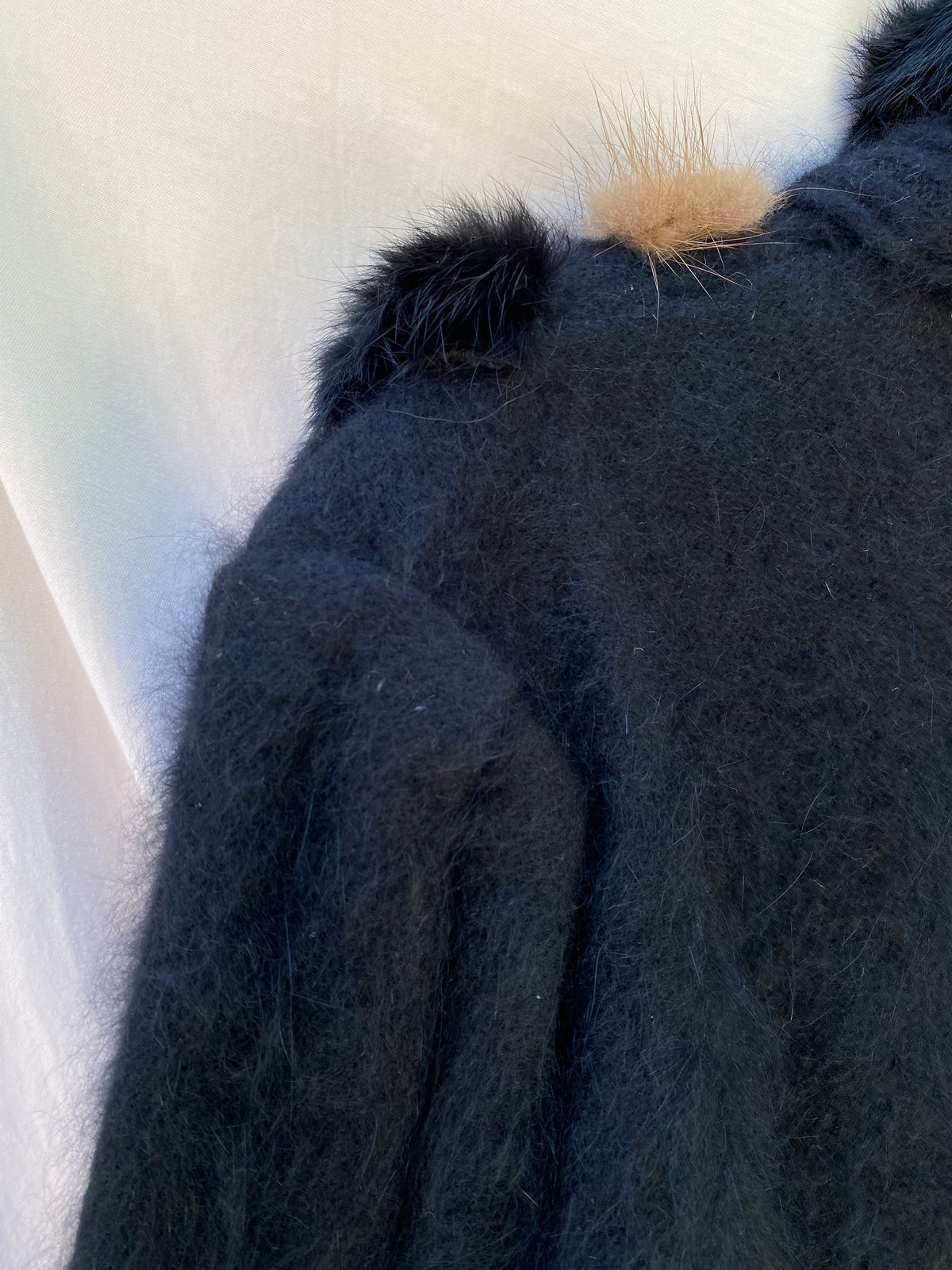 Detail of the puffed angora knit shoulder and sleeve