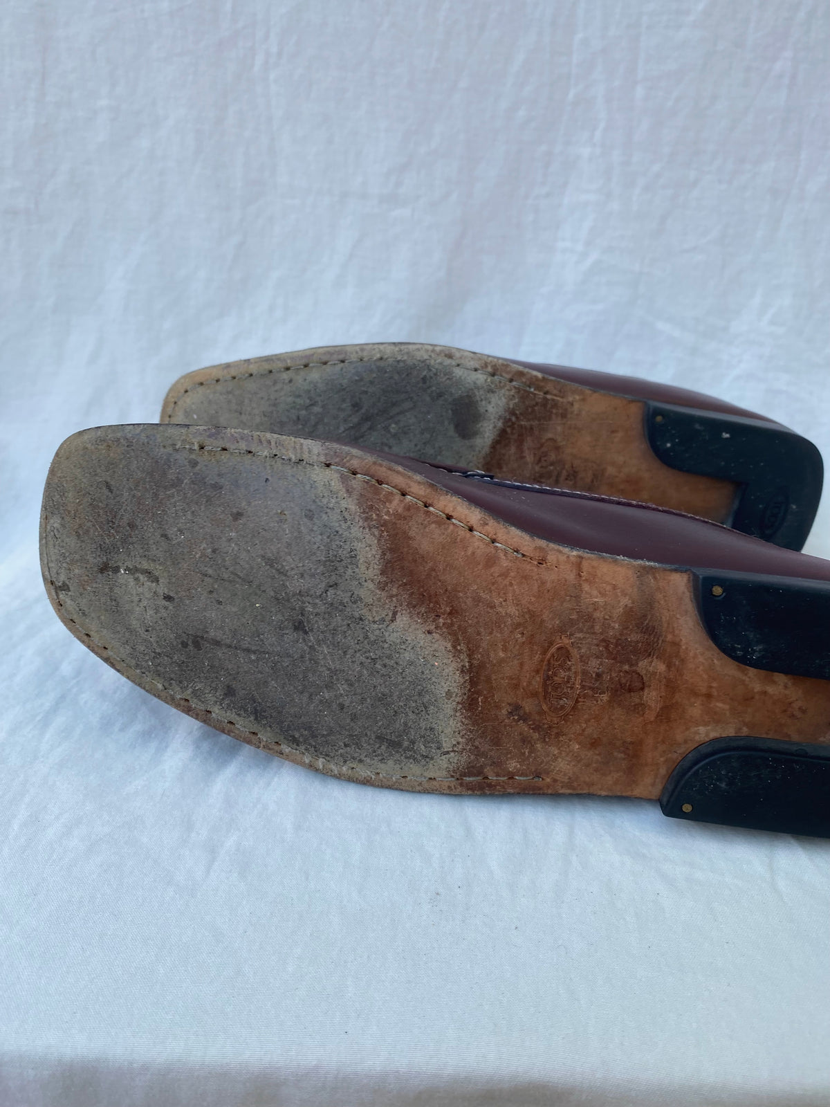 Forefoot of a Tod's loafer leather sole showing wear and soiling from use
