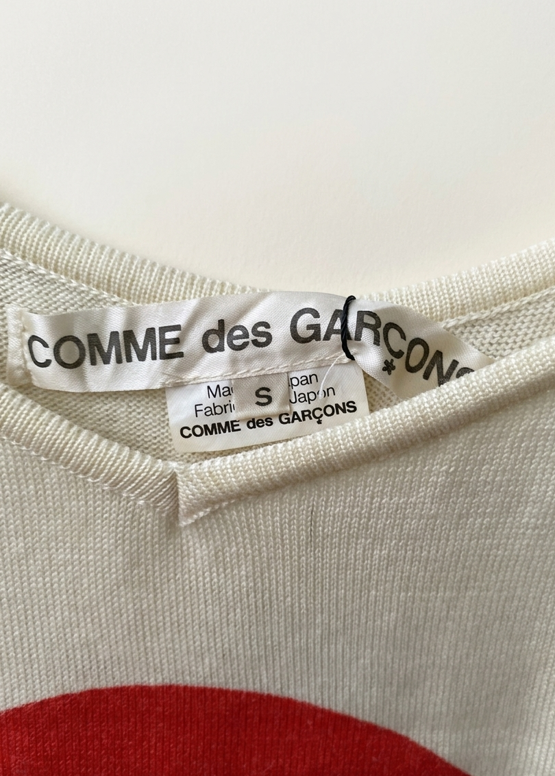 COMME des GARÇONS label close-up with iconic red heart logo on Grace and Nature tank