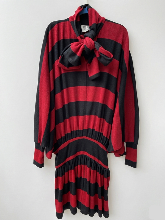 Red and black striped dress with a large bow on a white background