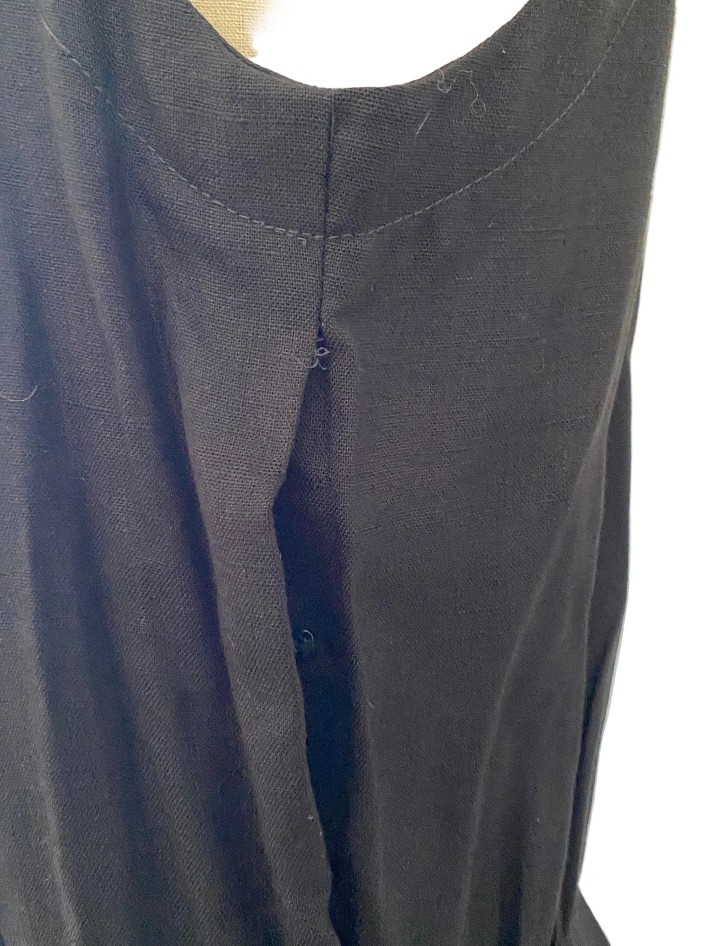 Close-up of a dark gray fabric with a circular cutout on a white background