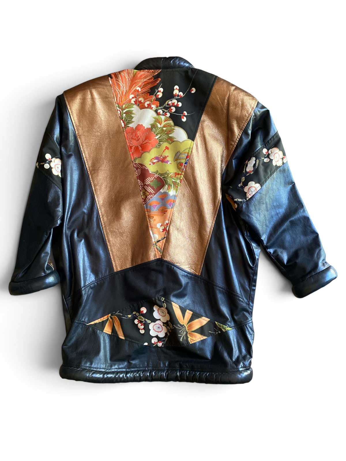 Opulent leather kimono jacket, back view laid flat with the oversized batwing sleeves spread, showing the floral silk panel down the spine and cherry blossom patches on each sleeve