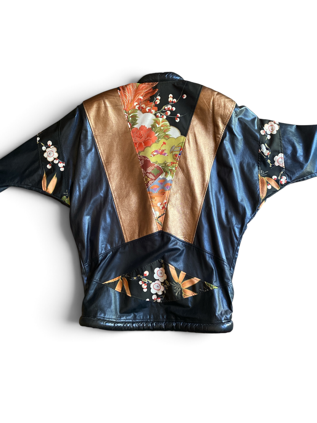 Opulent leather kimono jacket, back view laid flat, showing the floral and bamboo silk patch at the hem along with the bronze leather color-blocking