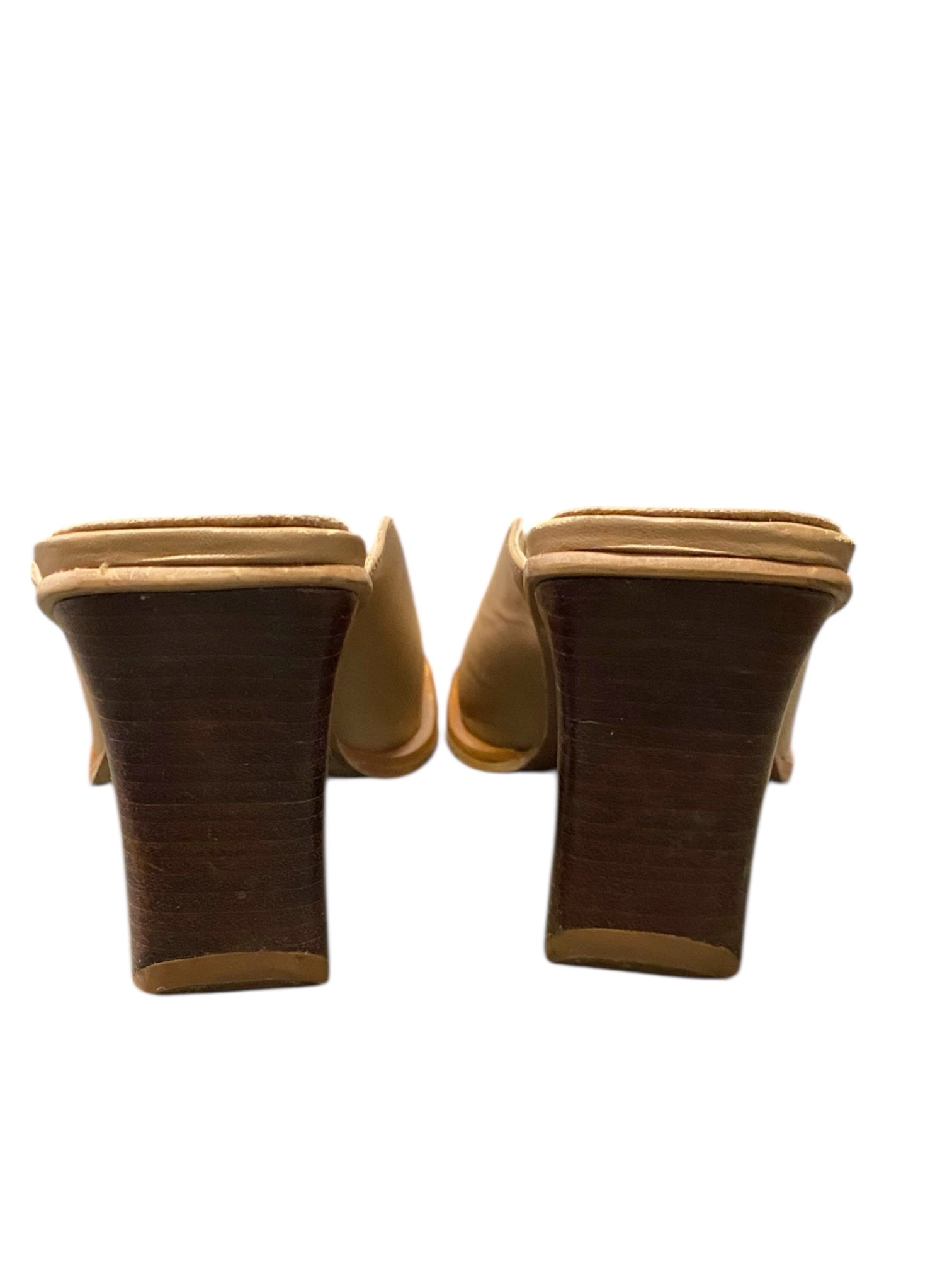 Pair of brown suede high-heeled shoes on a white background