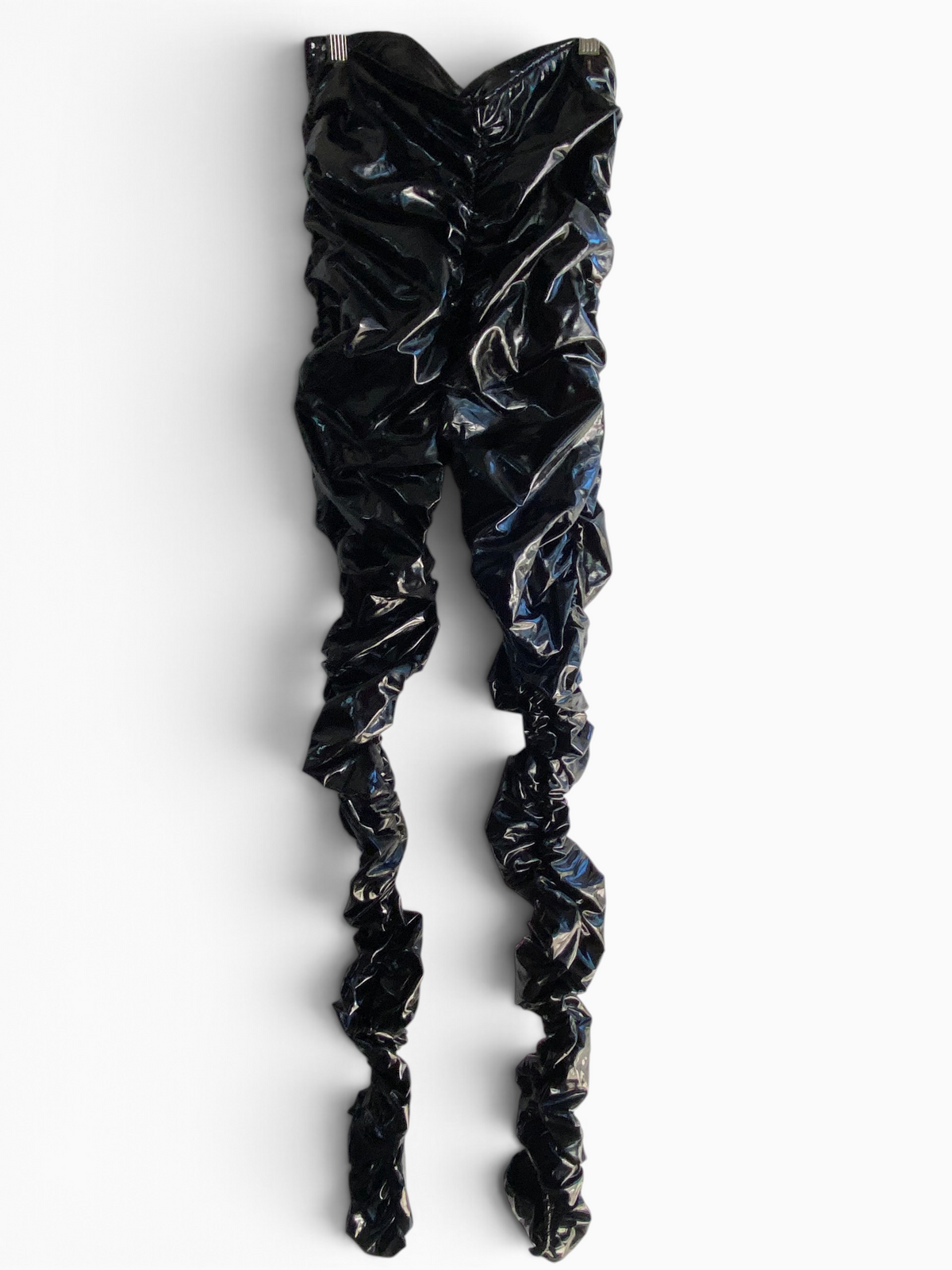 LaliSimone black shiny PU ruched pants with ankle slits and form-fitting design on a white background