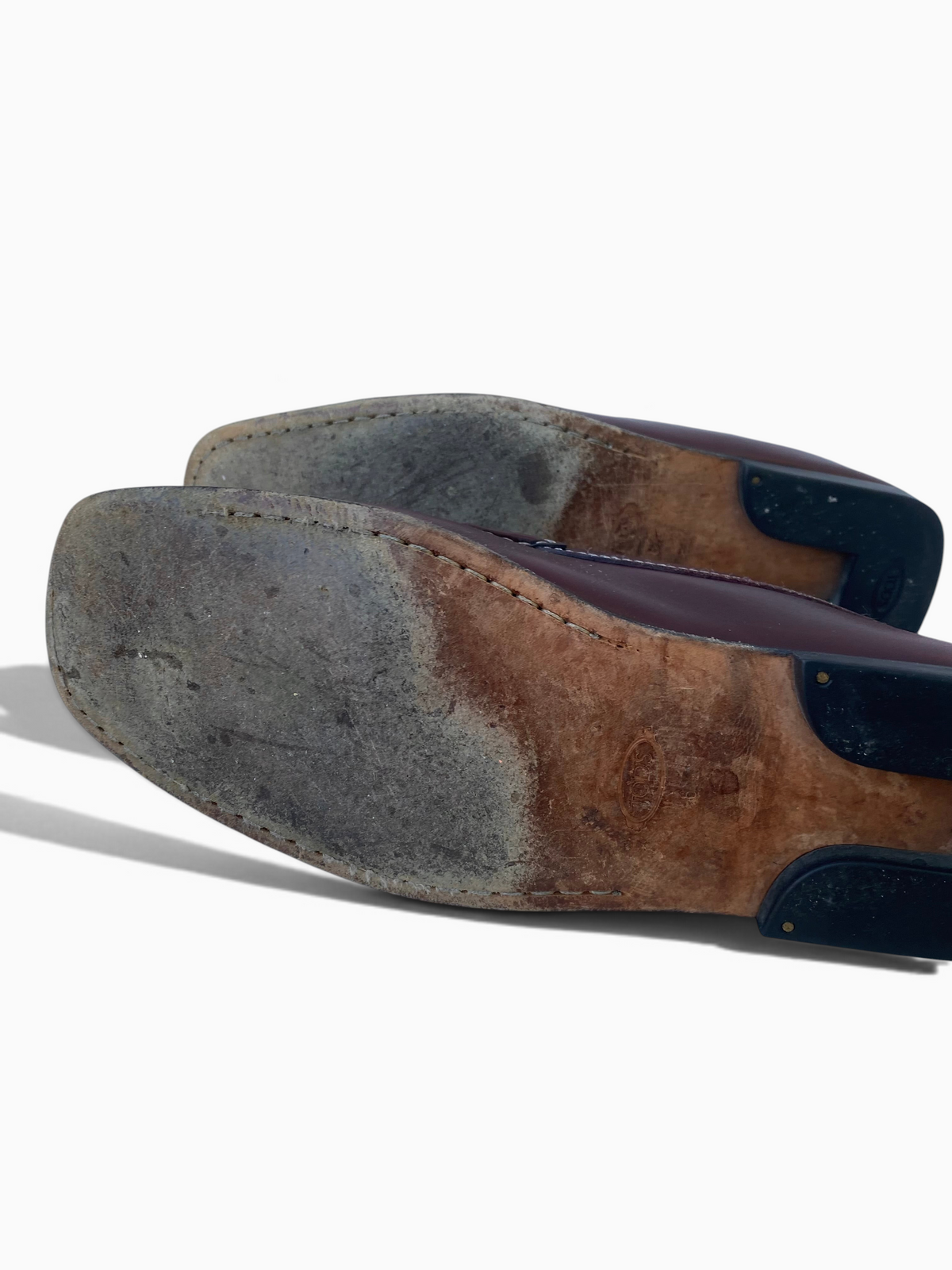 LaliSimone vintage Tod's oxblood leather penny loafers showing worn leather soles and rubber heel pads