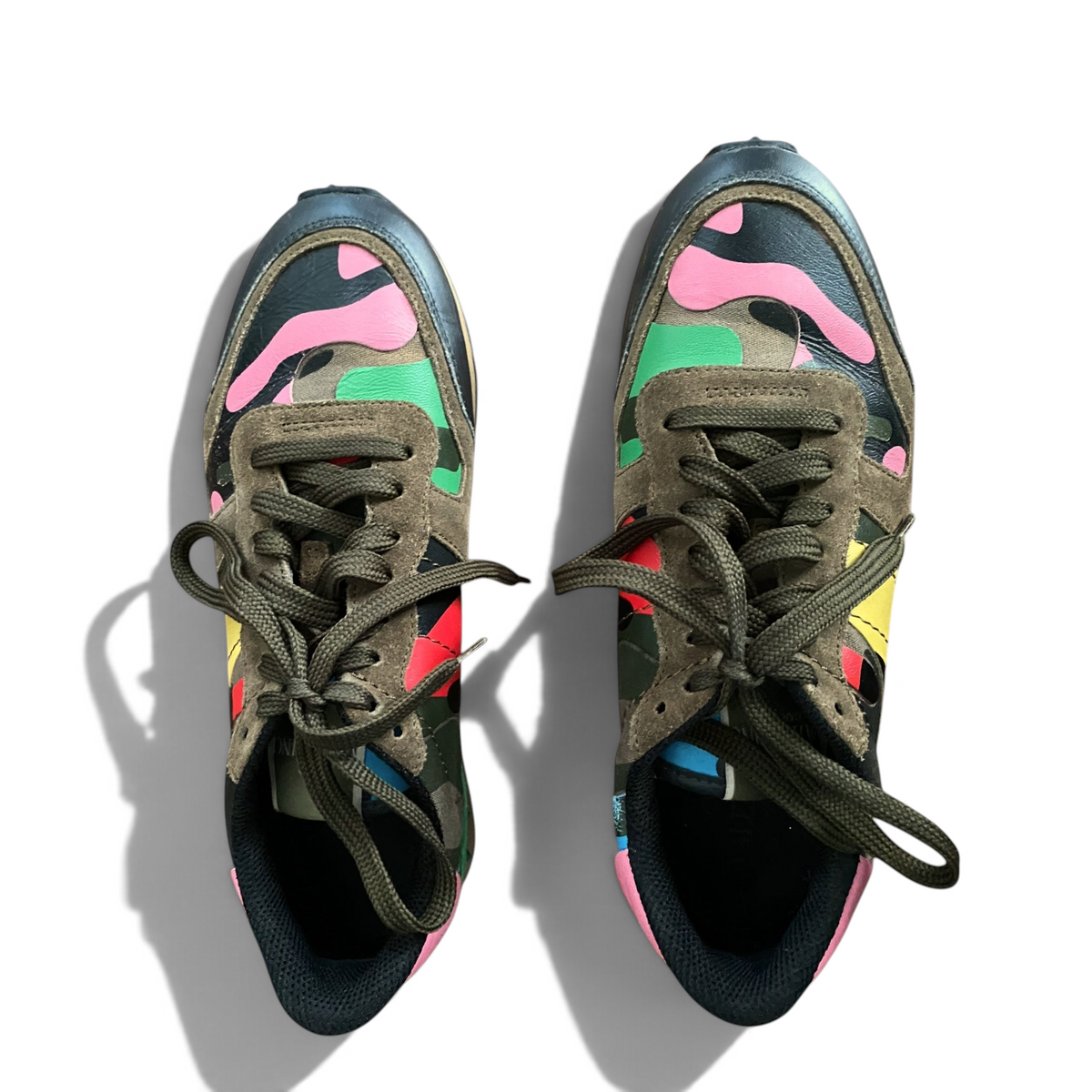 LaliSimone Valentino Garavani low top sneakers featuring a vibrant multi-colored camouflage print and suede accents.