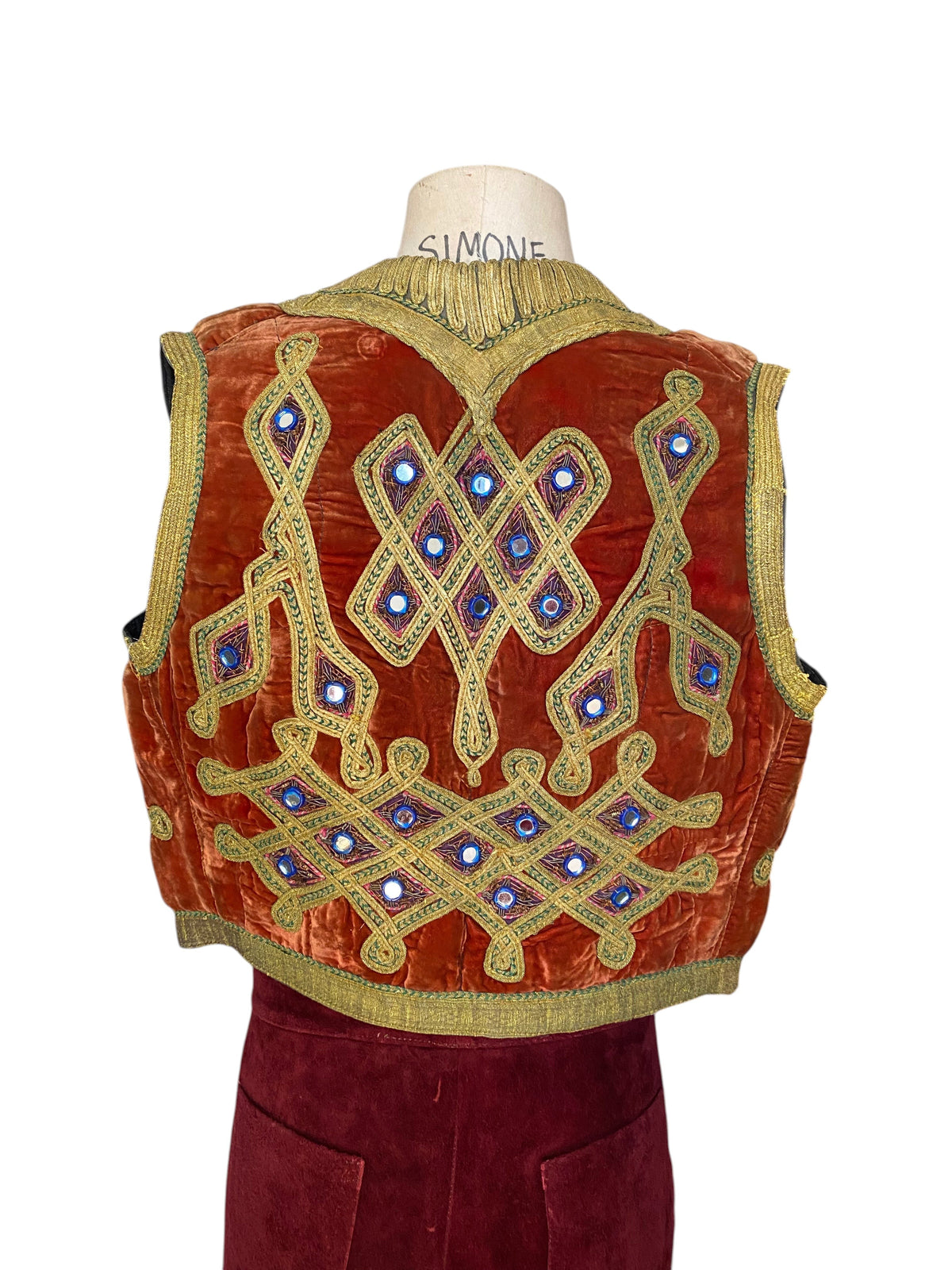 LaliSimone vintage rust-orange velvet Pashtun vest with gold zardozi embroidery and reflective shisha mirror details.