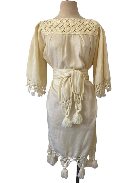 LaliSimone cream boho dress with crochet neckline, tie belt, and tassel trim. 3/4 sleeves.