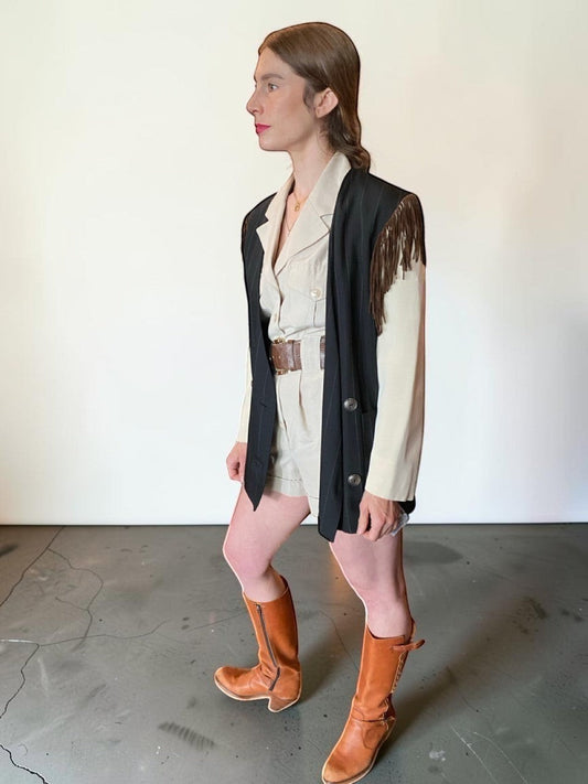 LaliSimone Ozbek striped jacket with brown fringe detail over a cream utility romper and brown boots.